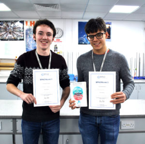 Physics students holding their awards